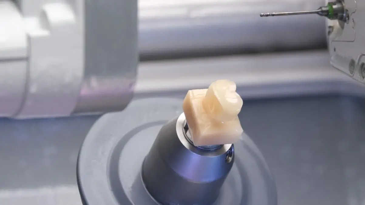 Micro CNC machining of a dental crown component in a precision setup.